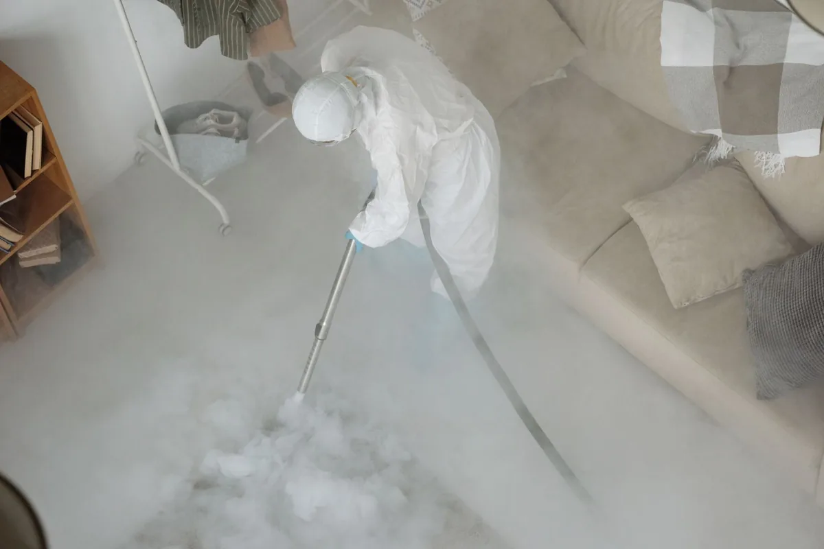 Biohazard cleanup technician in protective equipment, Blue Ridge, TX